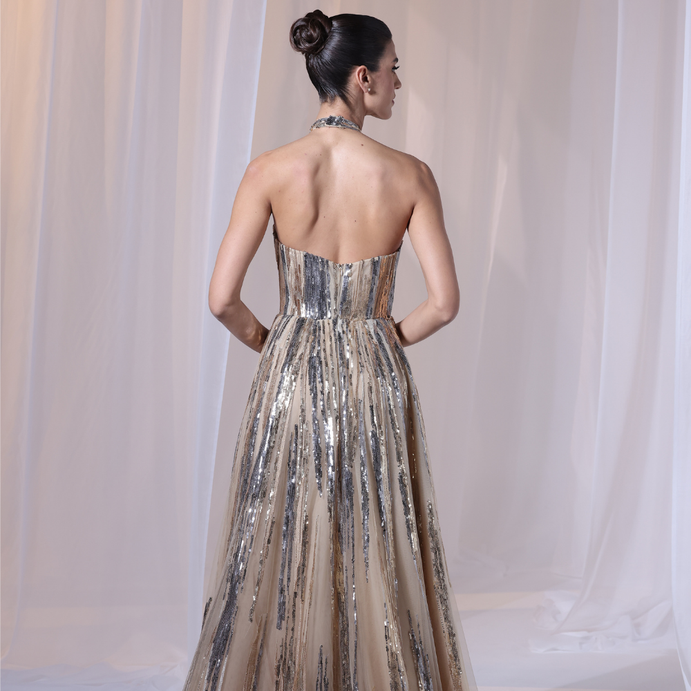 Shop online radiant champagne gown with delicate sequins, modern halter neckline and flowing silhouette, perfect for parties, receptions and special occasions.