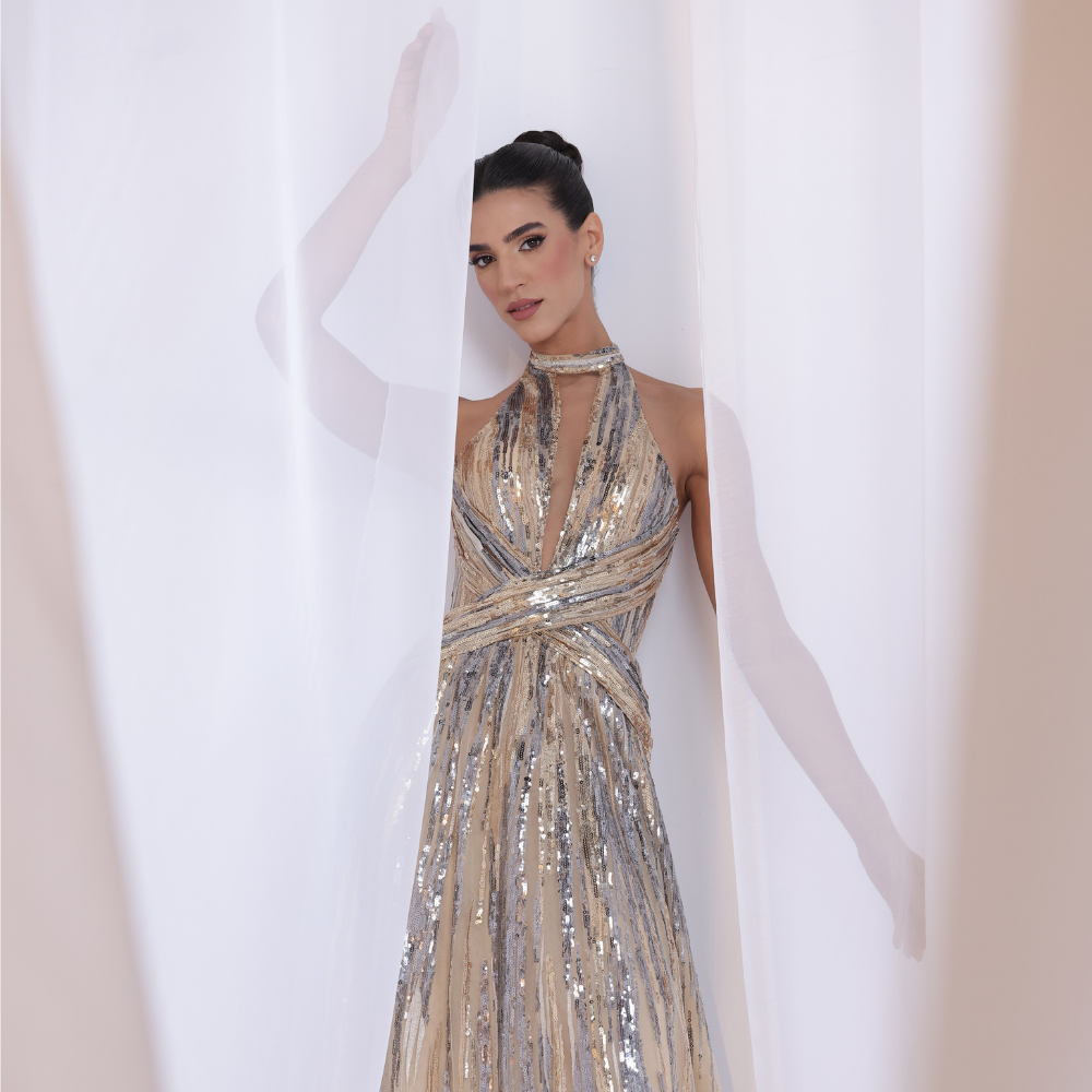 Shop online radiant champagne gown with delicate sequins, modern halter neckline and flowing silhouette, perfect for parties, receptions and special occasions.
