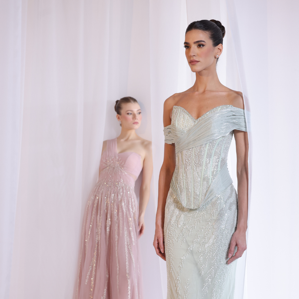 Shop online soft blush gown with one-shoulder silhouette, delicate shimmer detailing and flowing airy skirt, perfect for parties and special occasions.