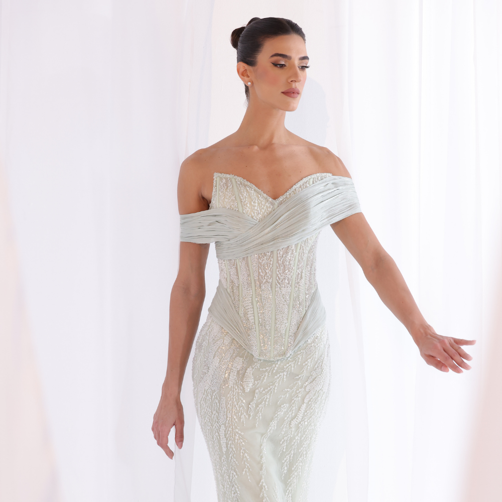 Shop online soft mint gown with embellished corset bodice, fitted silhouette and elegant off-shoulder draping, perfect for parties and special occasions.