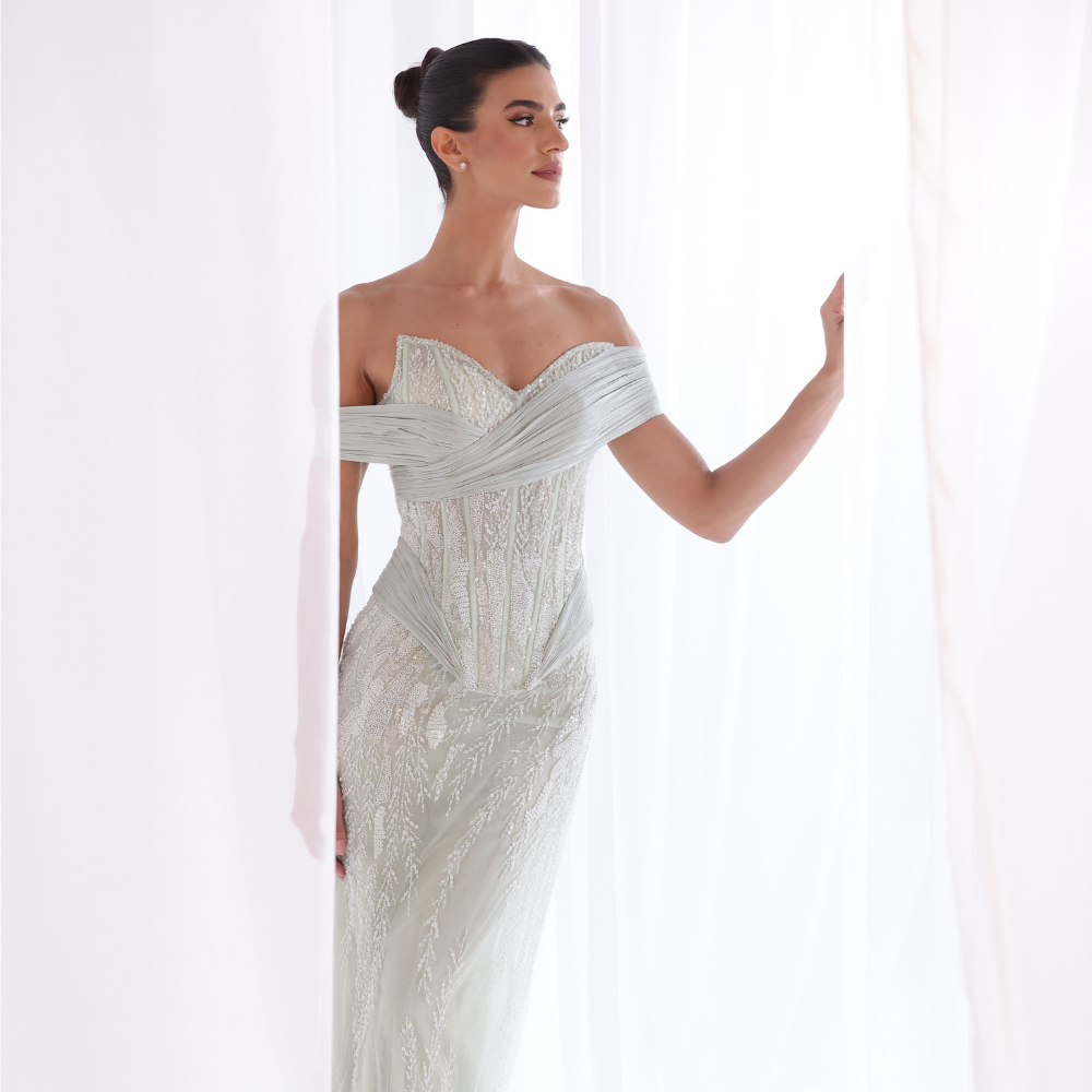 Shop online soft mint gown with embellished corset bodice, fitted silhouette and elegant off-shoulder draping, perfect for parties and special occasions.