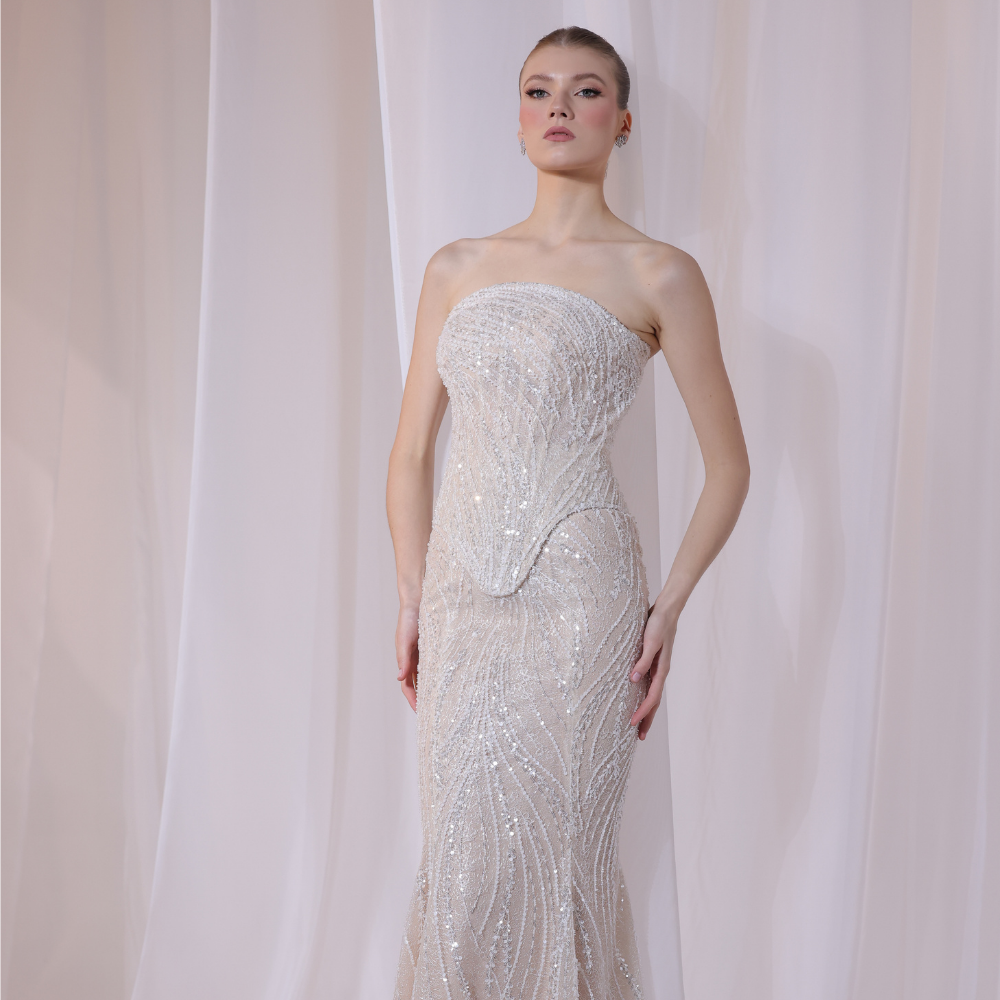 Shop online champagne strapless gown with delicate shimmering embellishments and sleek fitted silhouette, perfect for parties, receptions and special occasions.