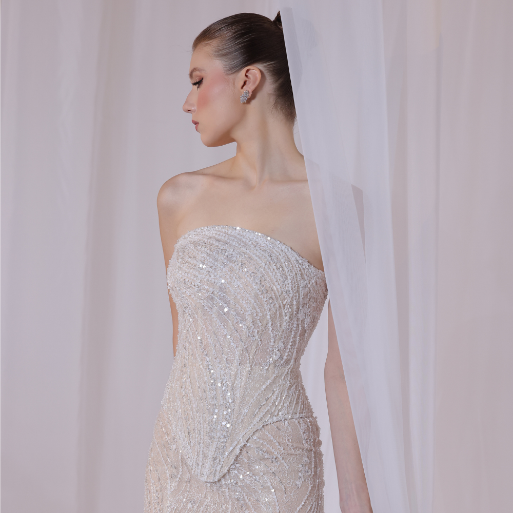 Shop online champagne strapless gown with delicate shimmering embellishments and sleek fitted silhouette, perfect for parties, receptions and special occasions.