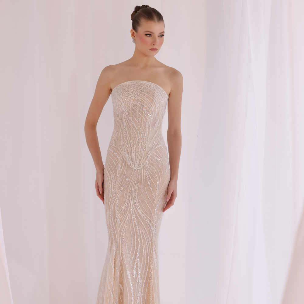 Shop online champagne strapless gown with delicate shimmering embellishments and sleek fitted silhouette, perfect for parties, receptions and special occasions.