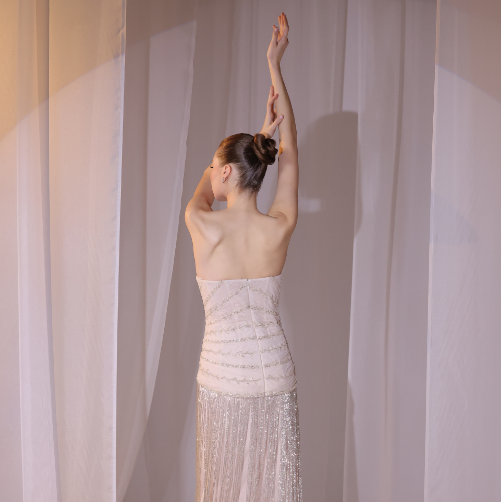 Shop online blush embellished gown with delicate detailing and fluid shimmering layers, inspired by Charleston elegance and perfect for special occasions.
