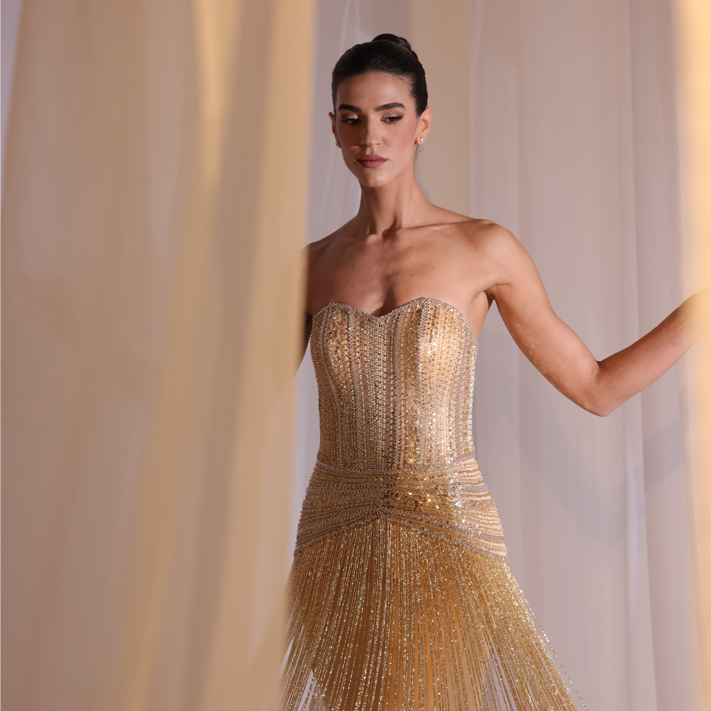 Shop online golden Charleston-inspired gown with fully embellished bodice and shimmering fringe detailing, perfect for parties and special occasions.
