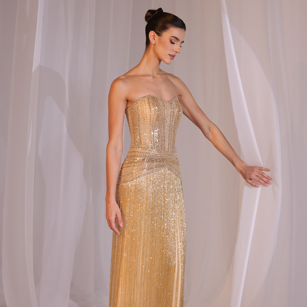 Shop online golden Charleston-inspired gown with fully embellished bodice and shimmering fringe detailing, perfect for parties and special occasions.