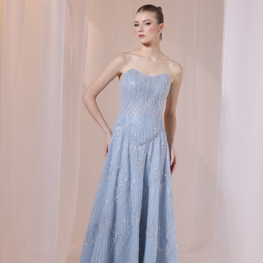 Shop online soft blue gown with subtle shimmer and flowing textured layers, perfect for parties, evening events and special occasions.