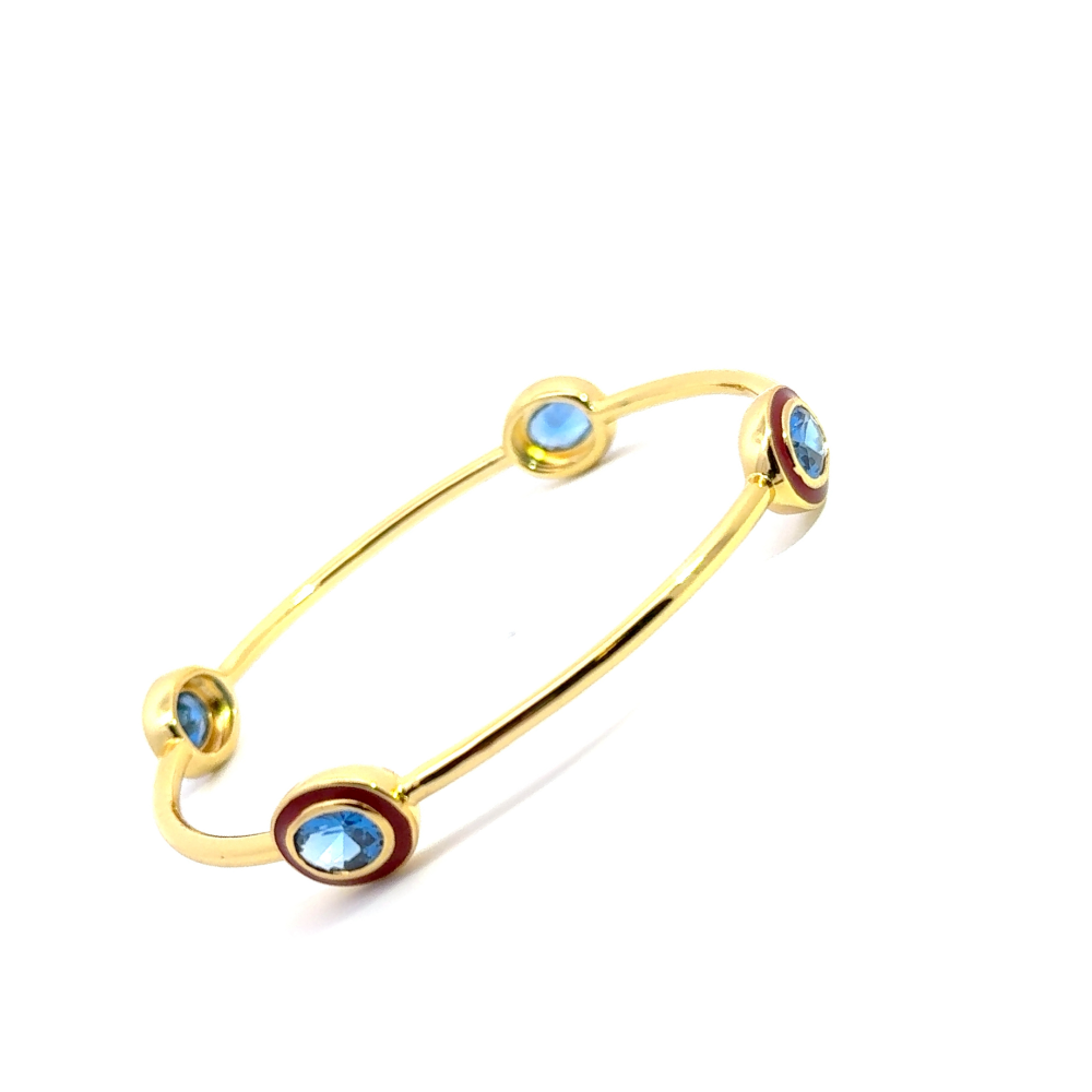 Bohemian 22K gold plated bangle with sparkling oval created Spinel and red enamel detailing. Perfect for stacking or statement styling. Shop premium jewelry online.