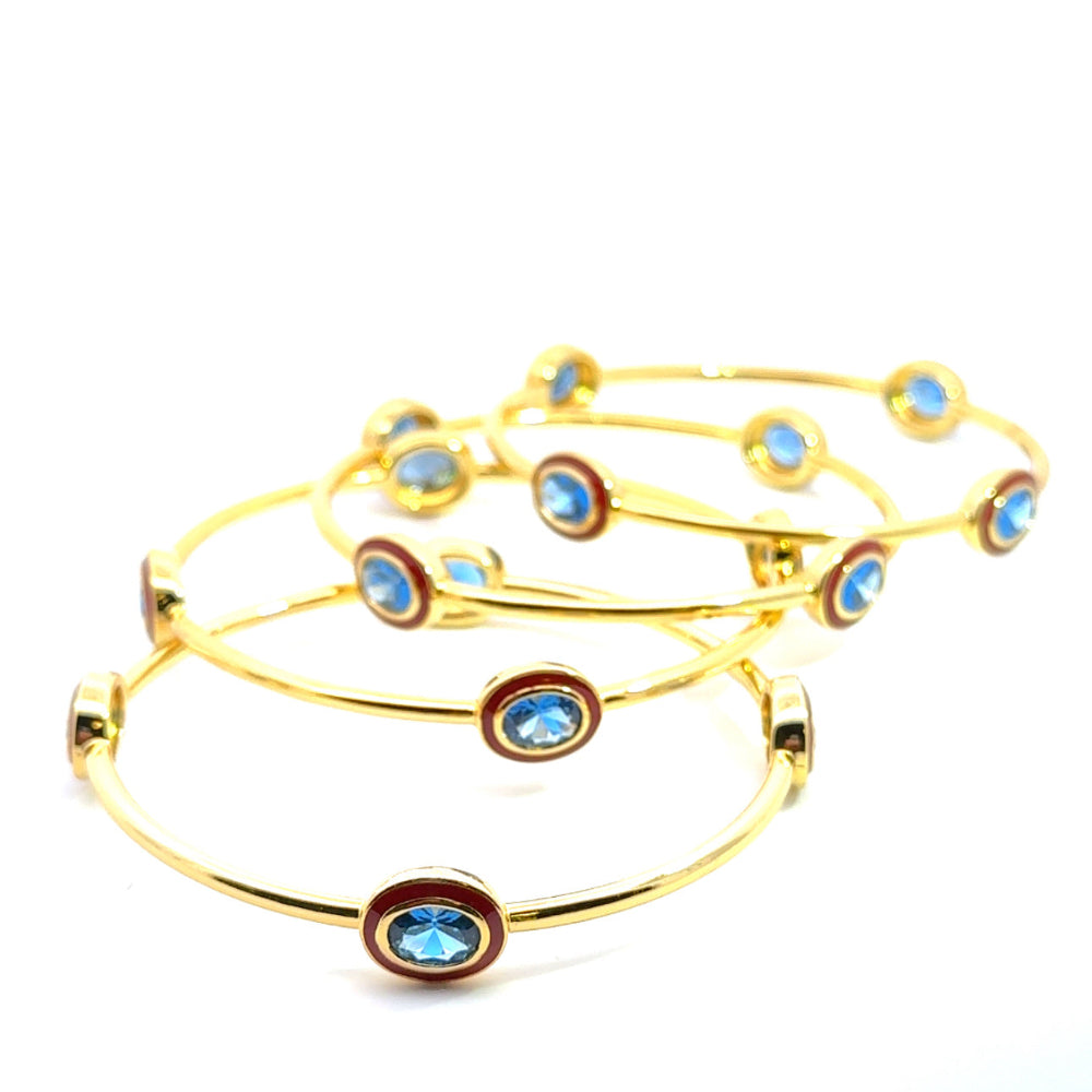 Bohemian 22K gold plated bangle with sparkling oval created Spinel and red enamel detailing. Perfect for stacking or statement styling. Shop premium jewelry online.