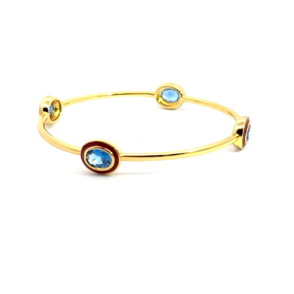 Bohemian 22K gold plated bangle with sparkling oval created Spinel and red enamel detailing. Perfect for stacking or statement styling. Shop premium jewelry online.