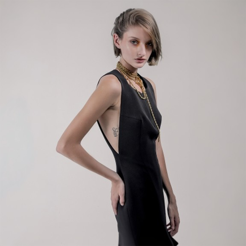 Long chain necklace with oversized ring.