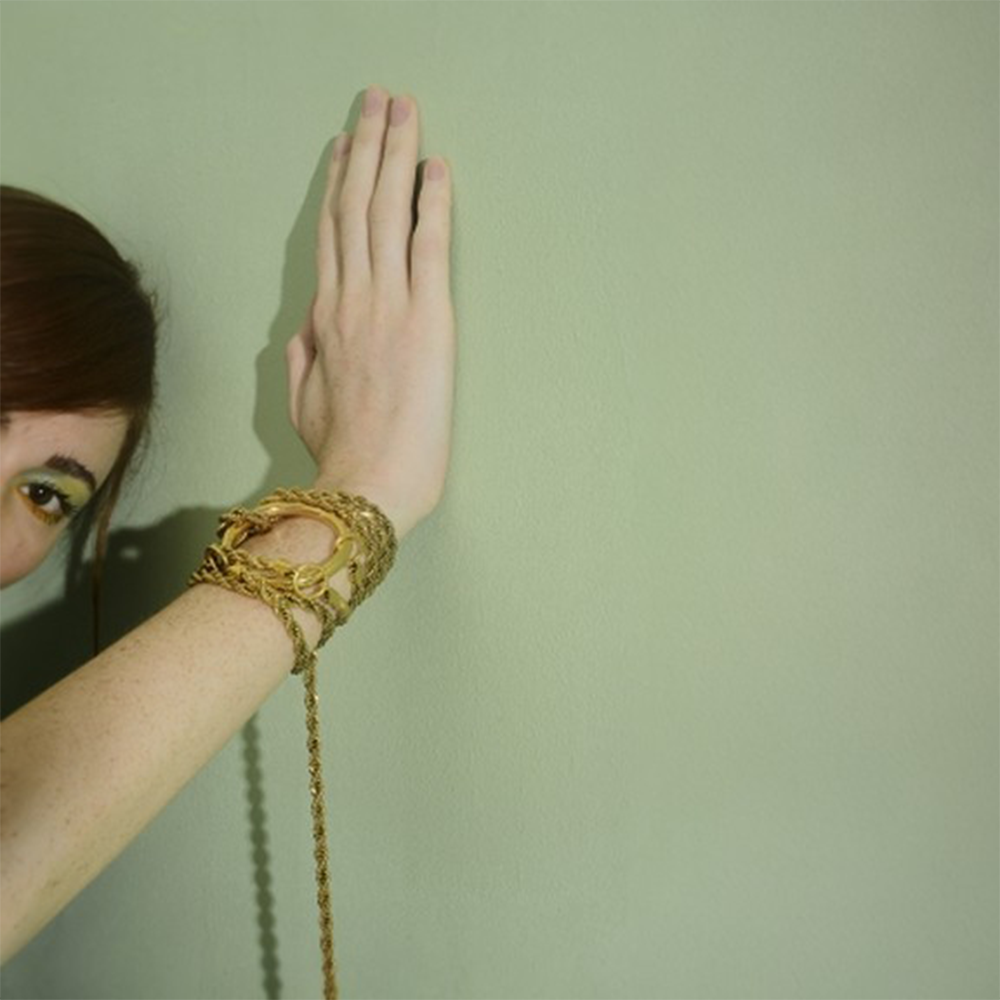 Long chain necklace with oversized ring.