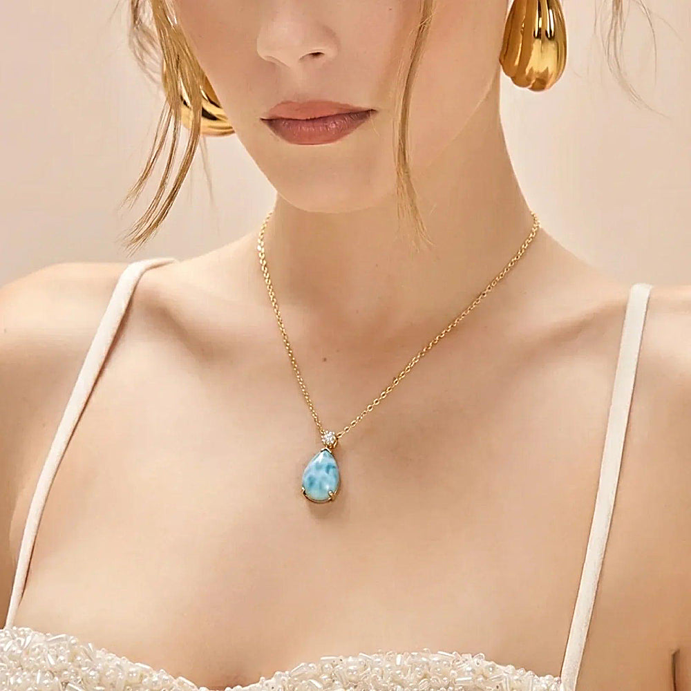 Discover the Mermaid’s Tear Larimar Necklace at The Luxe Maison, featuring naturally unique blue larimar stones inspired by the beauty and serenity of tropical oceans.