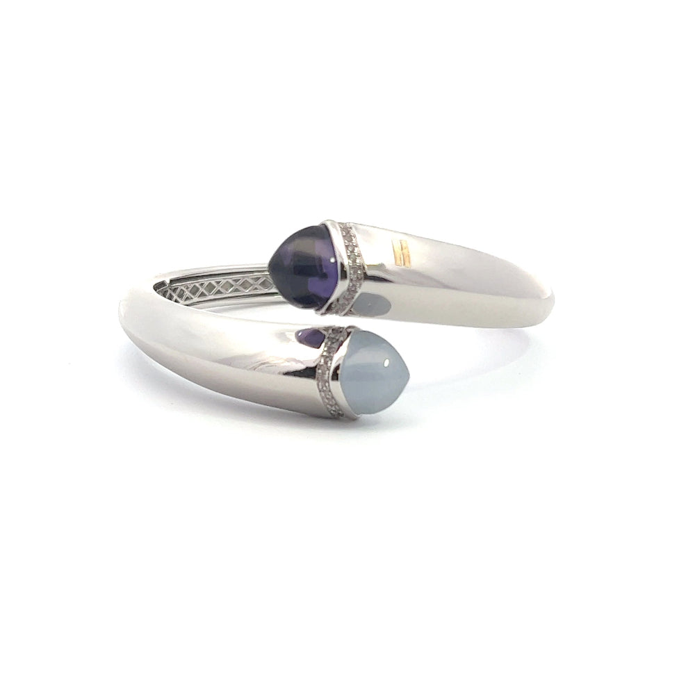 Elegant rhodium plated cuff bracelet with colored pyramidal crystals and sparkling pavé cubic zirconia accents. Perfect for modern luxe styling. Shop premium jewelry online.