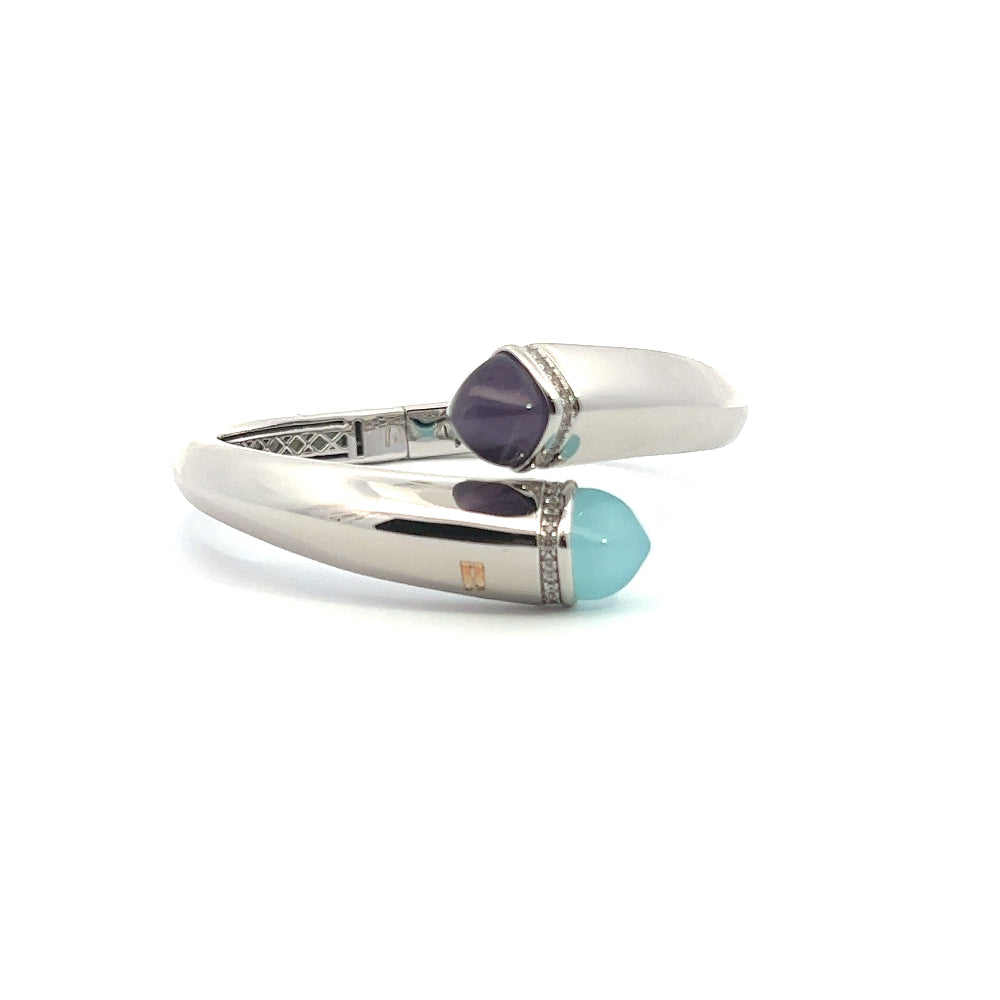 Elegant rhodium plated cuff bracelet with colored pyramidal crystals and sparkling pavé cubic zirconia accents. Perfect for modern luxe styling. Shop premium jewelry online.