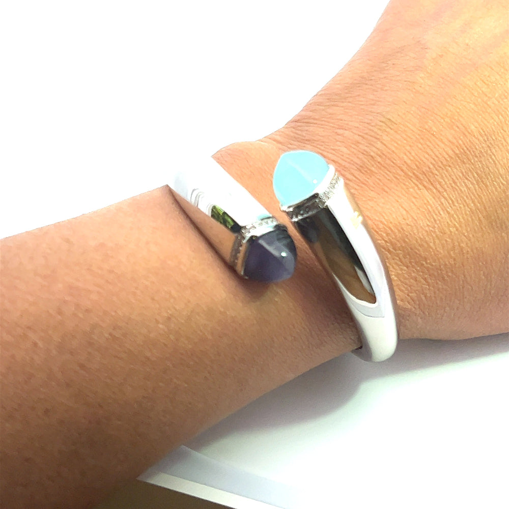 Elegant rhodium plated cuff bracelet with colored pyramidal crystals and sparkling pavé cubic zirconia accents. Perfect for modern luxe styling. Shop premium jewelry online.