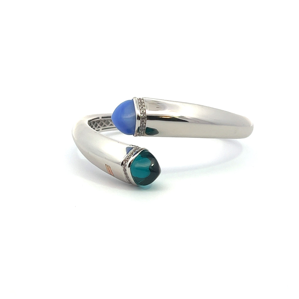 Elegant rhodium plated cuff bracelet with colored pyramidal crystals and sparkling pavé cubic zirconia accents. Perfect for modern luxe styling. Shop premium jewelry online.