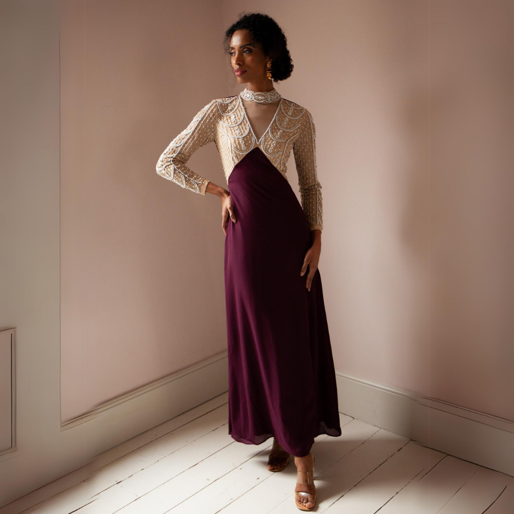 The Miley Gown features a high neckline with sheer v detail.