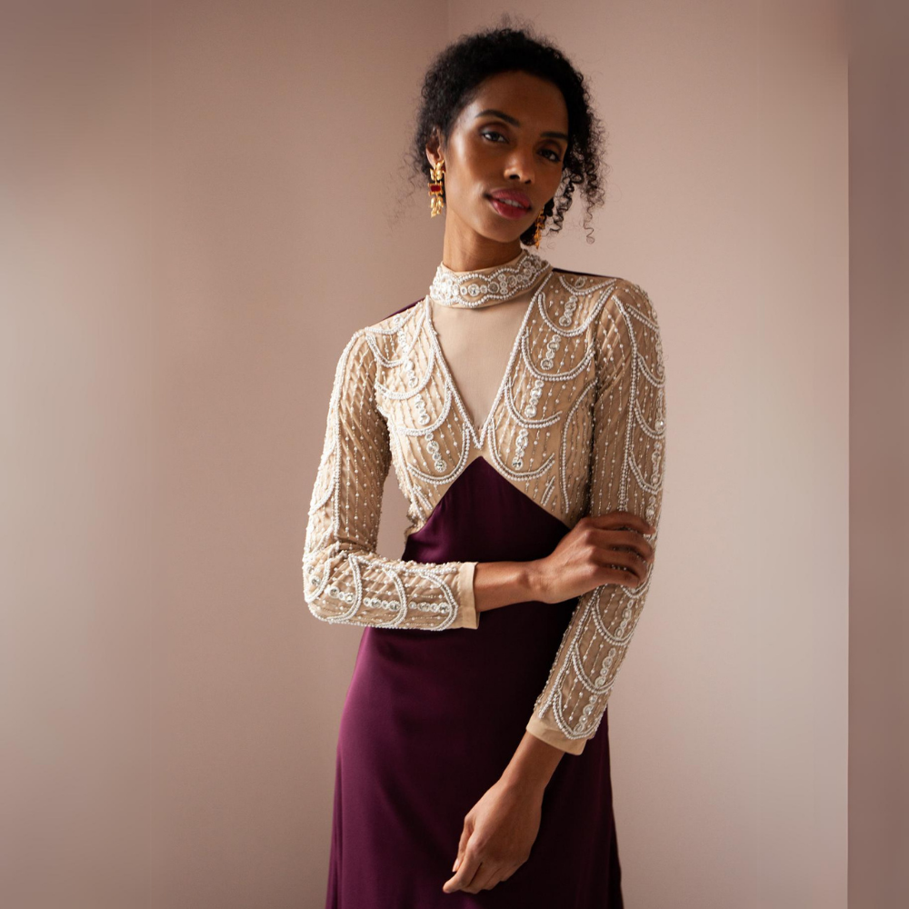 The Miley Gown features a high neckline with sheer v detail.