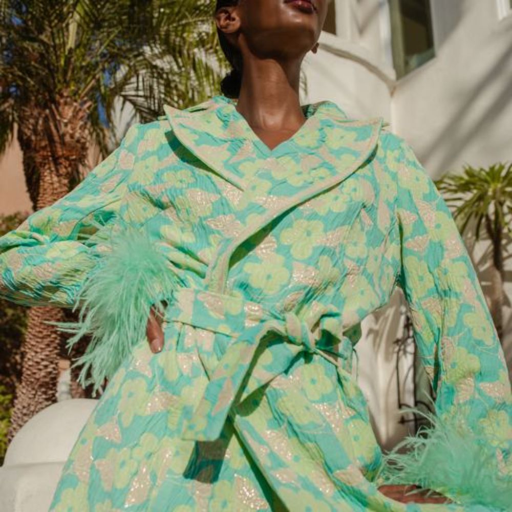 Signature Mint Jacqueline Coat With Detachable Feather Cuffs has printed fabric with an epaulette details. 