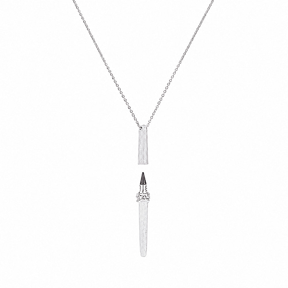 Discover the Muse Silver Pen Necklace at The Luxe Maison, featuring a sculptural silver-plated pendant with a functional graphite tip, designed to celebrate creativity, self-expression, and the art of writing.
