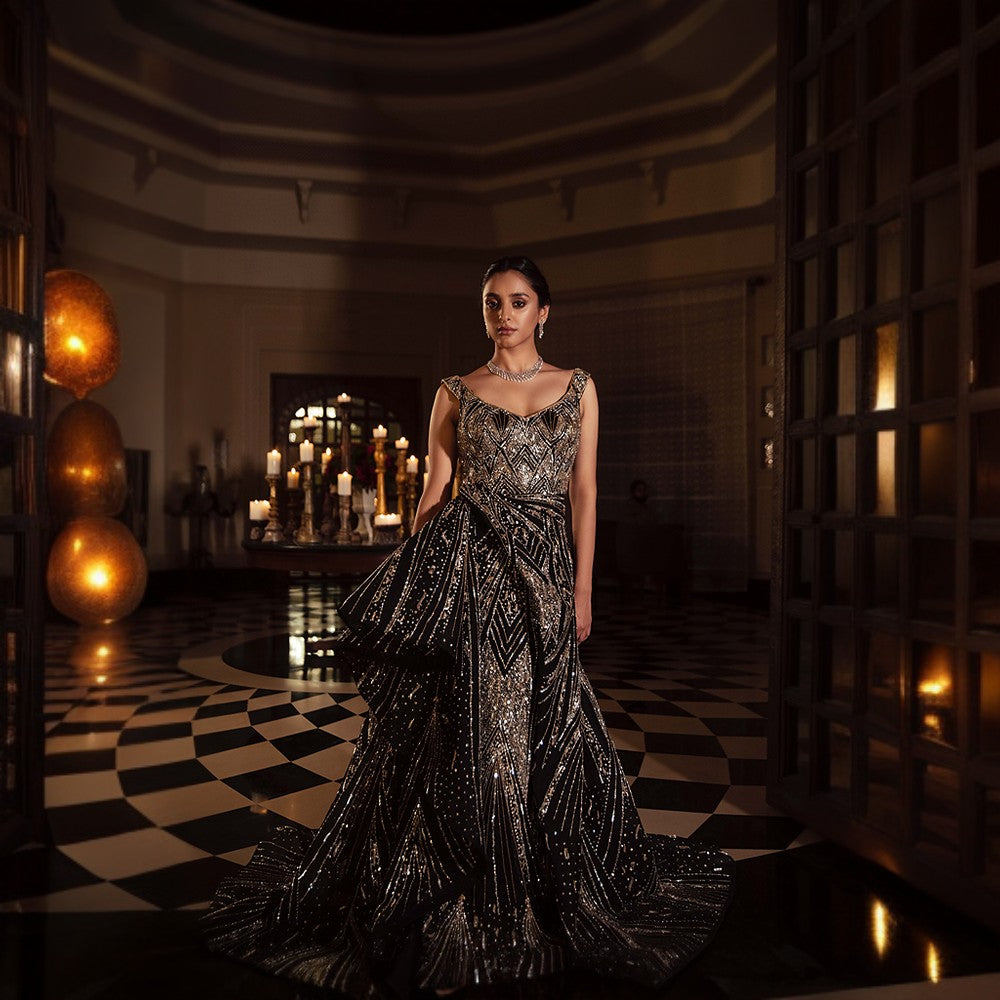 Scintillating Cosmos depicted through Signature embroideries with wraparound bustle over pillar gown with train.