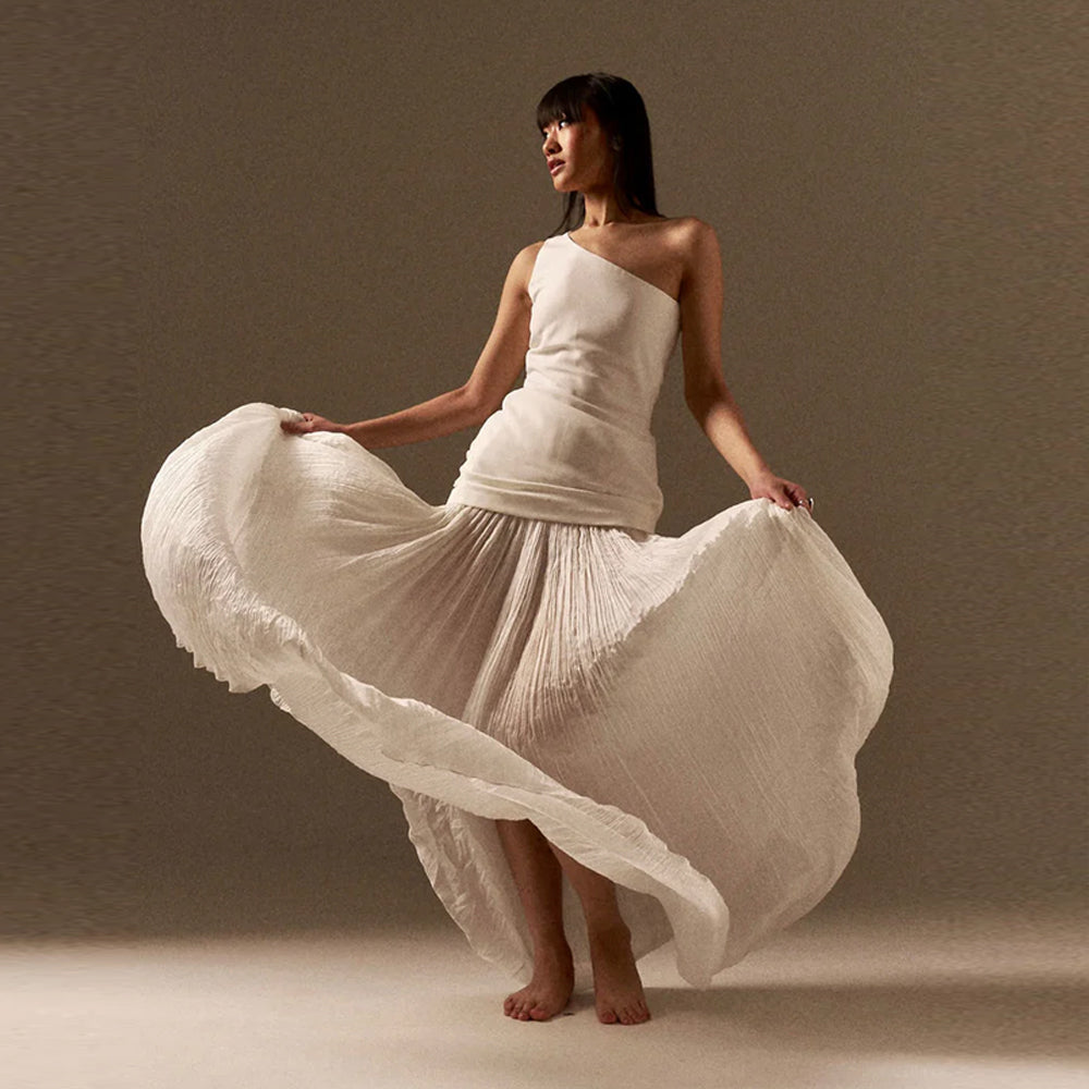 One shoulder top with chiffon skirt and tulle detail, perfect for getaways. Shop online from our curated edit of premium fashion.