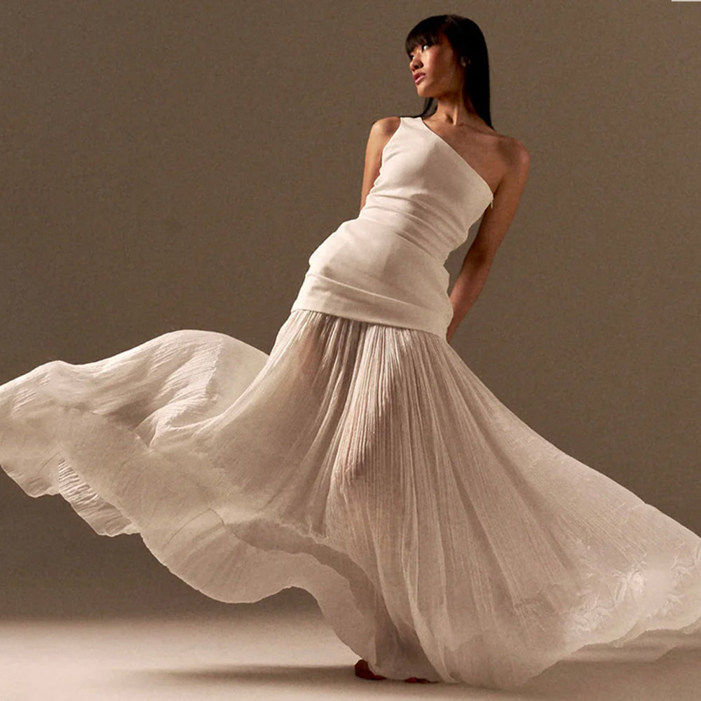 One shoulder top with chiffon skirt and tulle detail, perfect for getaways. Shop online from our curated edit of premium fashion.