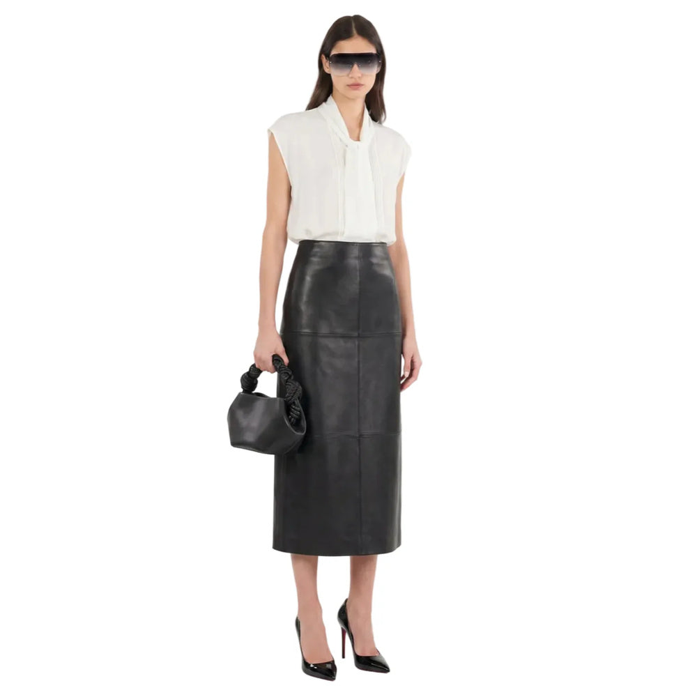 Shop online from our exclusive website and discover the Olive Leather Midi Skirt by Benedetti Life, crafted from plant-based olive leather for a sleek silhouette, modern elegance, and sustainable luxury.