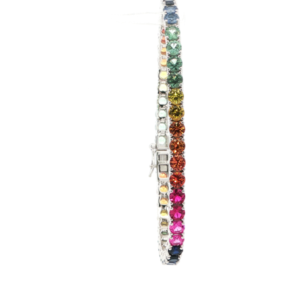 Rhodium-plated sterling silver rainbow ombre bracelet with lab-created yellow, pink, orange, blue, and green sapphire stones with ruby accents for a vibrant modern look. Shop premium jewelry online.