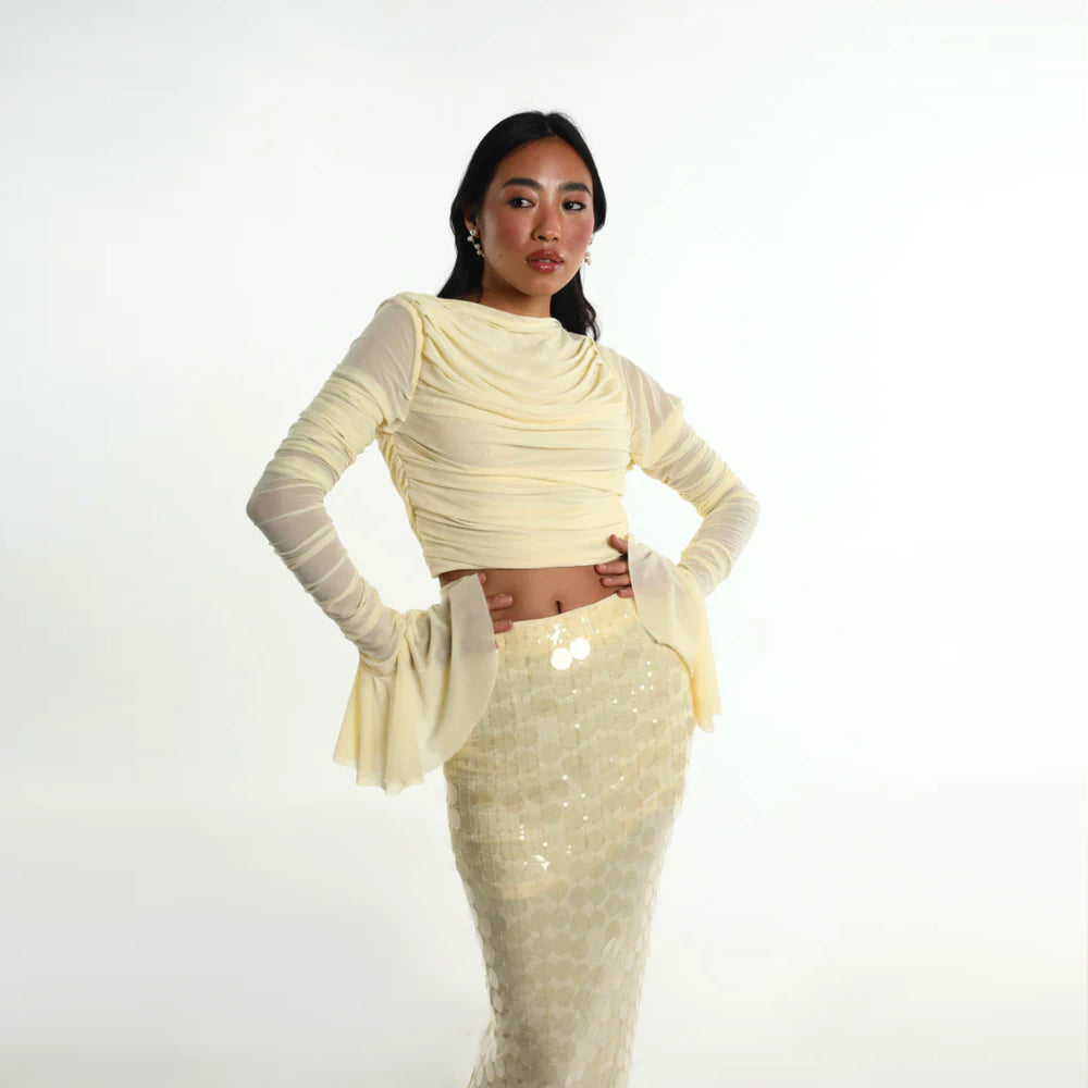 Pastel yellow set with ruched mesh top and sequin skirt, perfect for parties. Shop online from our curated edit of premium fashion.