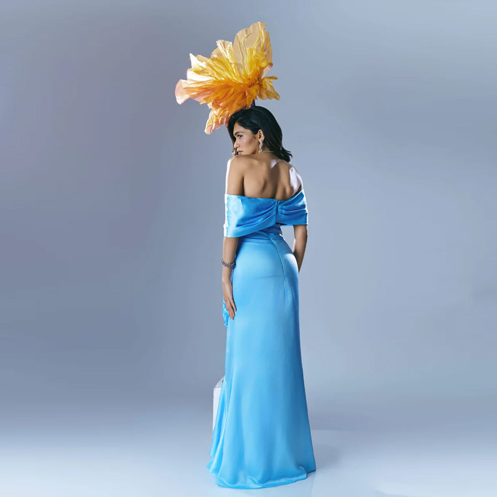 Sky blue off shoulder gown with waist cutout and ruffles, perfect for weddings. Shop online from our exclusive collection of premium styles.