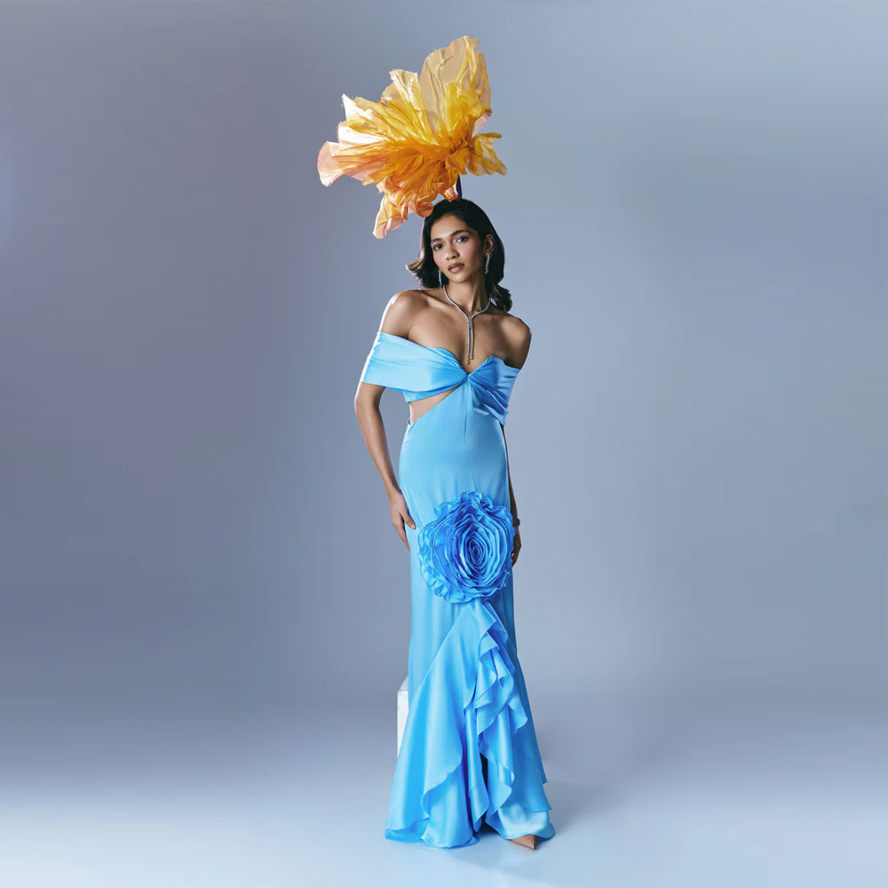 Sky blue off shoulder gown with waist cutout and ruffles, perfect for weddings. Shop online from our exclusive collection of premium styles.