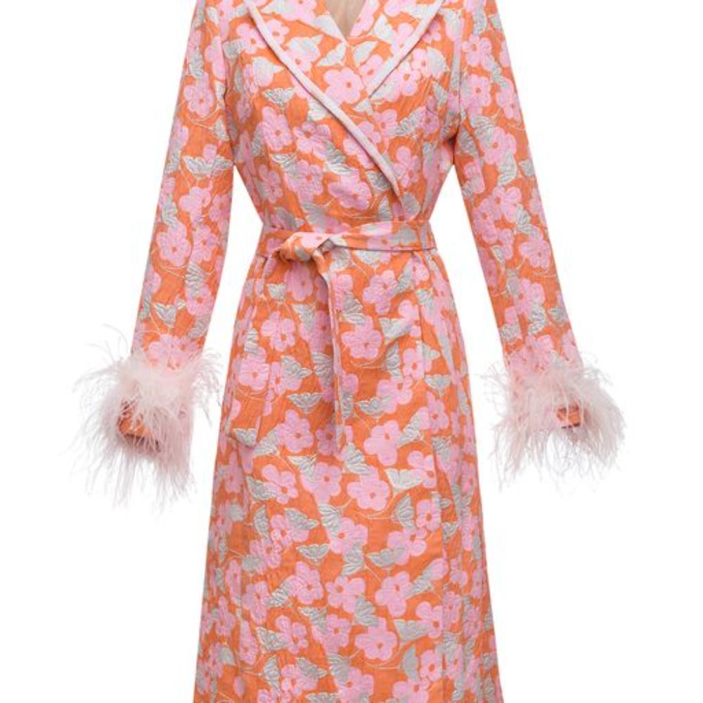 Pink coat has belted waist and decorated with detachable feathers cuffs.