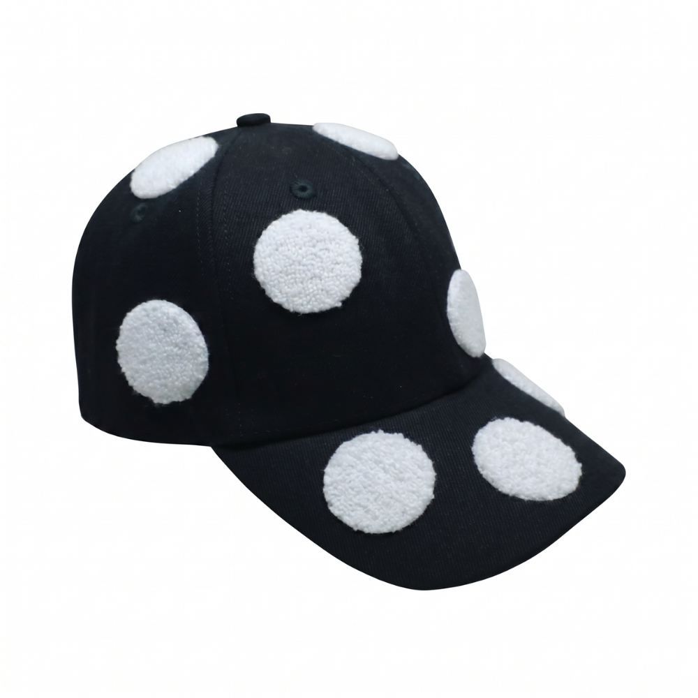 Black structured cap with bold 3D polka dots. Shop premium designer styles online.