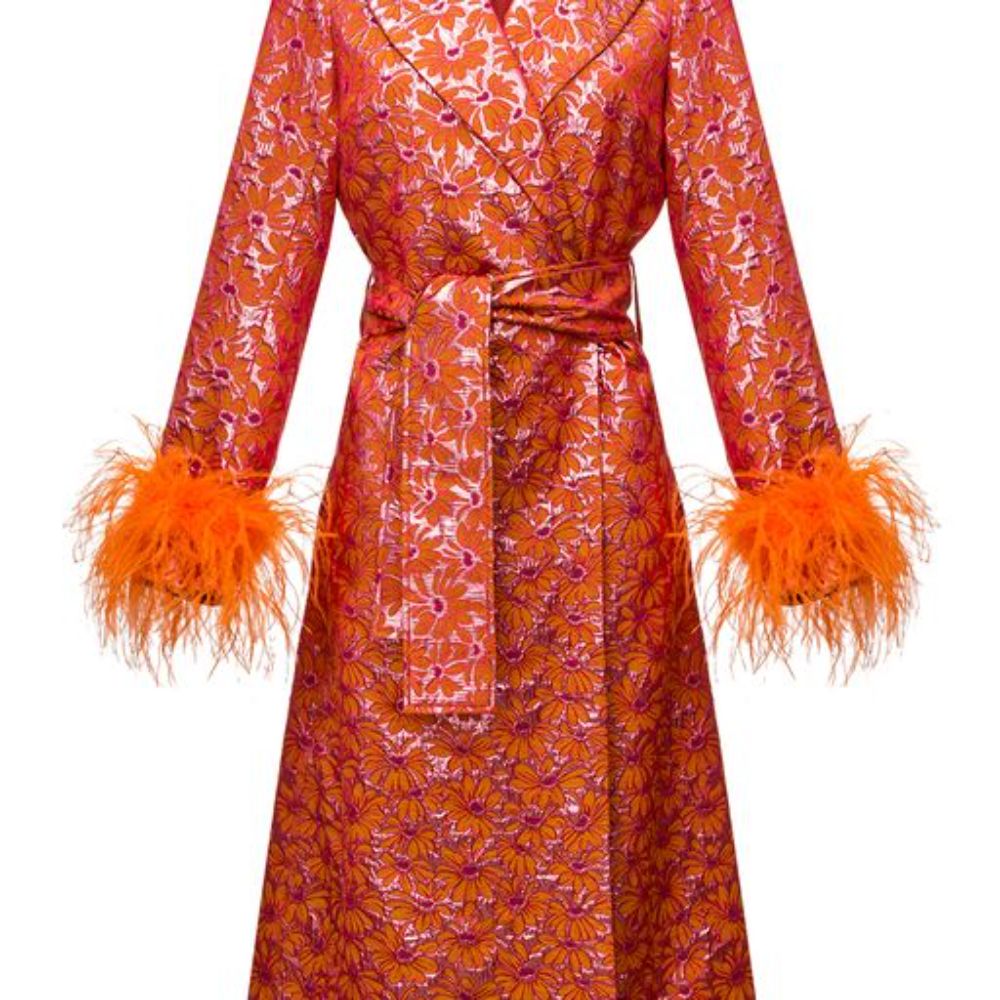 Signature coat has belted waist and decorated with detachable feathers cuffs. 