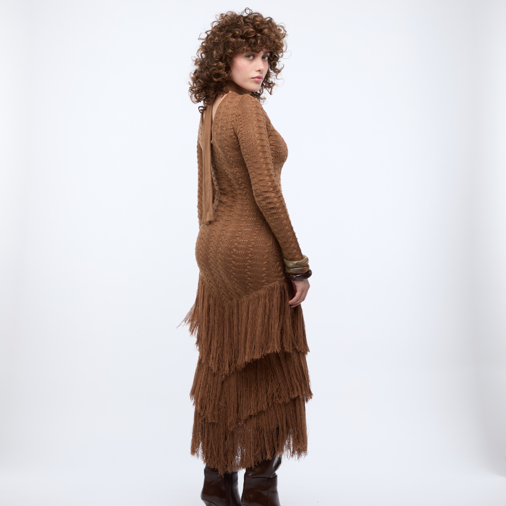 Shop this Brown Knit Maxi Dress at TLM, featuring long sleeves, sheer texture and waist cut-outs. Explore luxury fashion on The Luxe Maison website.