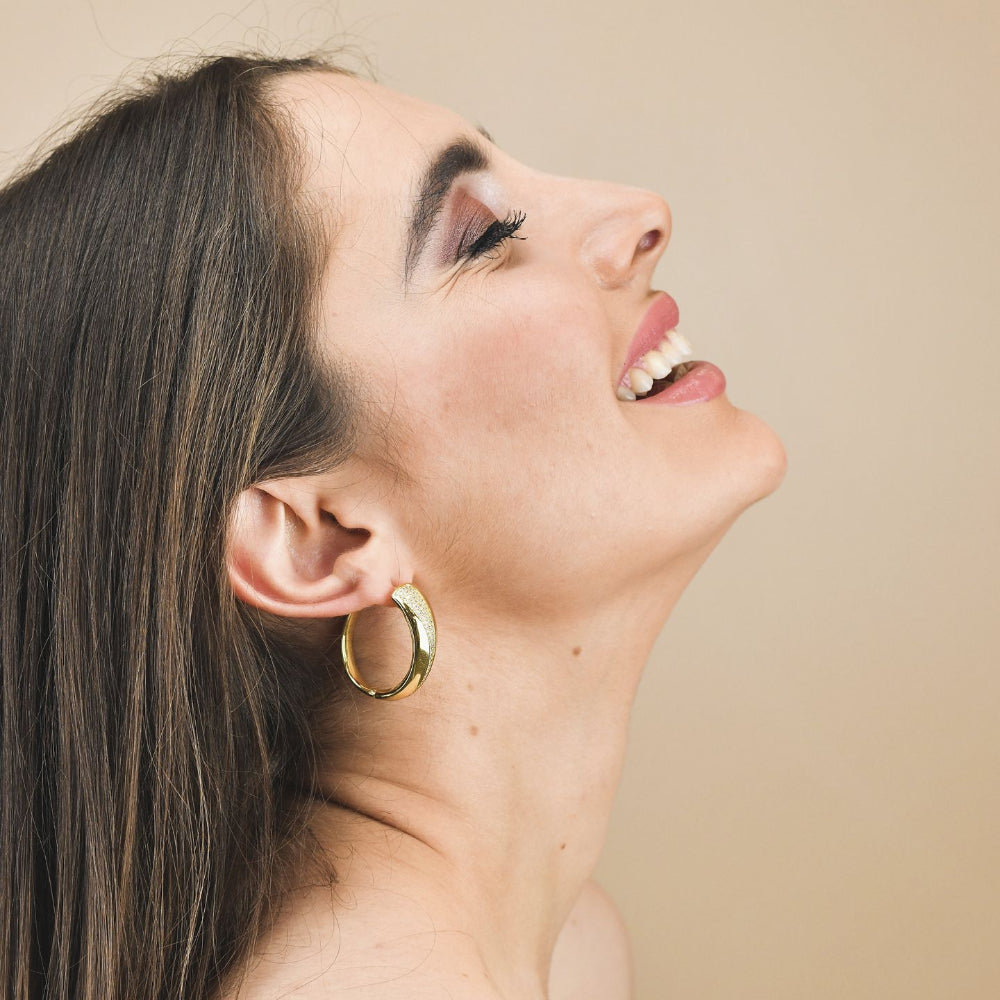 Shop online premium gold plated oval hoop earrings with sparkling pavé cubic zirconia detailing for elegant everyday styling.