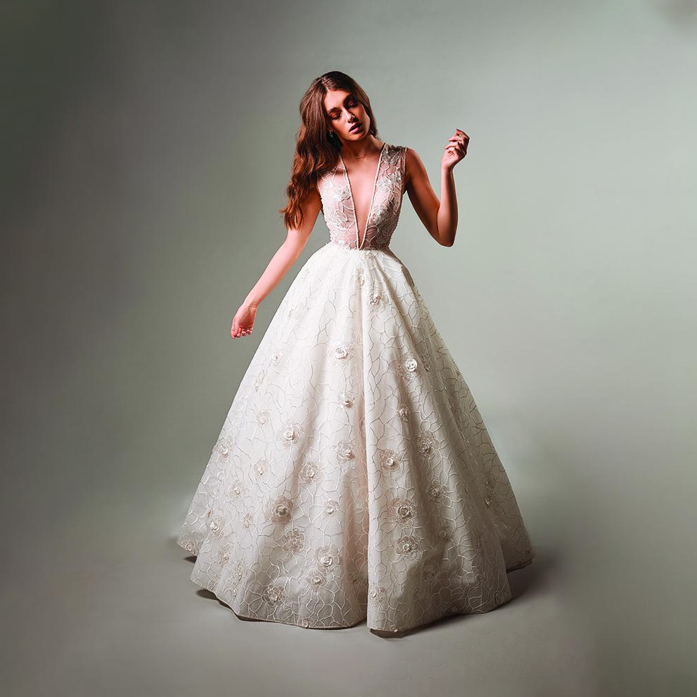 Gathered mesh gown. Soft creations embellished with floral motives and sinuous natural lines.