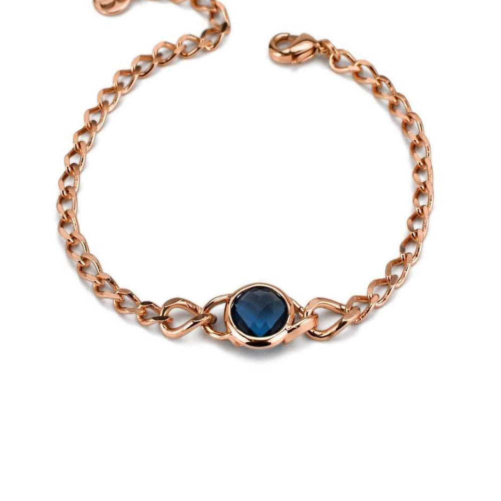 Rose gold plated bronze curb bracelet with a blue sapphire crystal interlayer pendant for a sleek modern statement. Shop premium jewelry online.