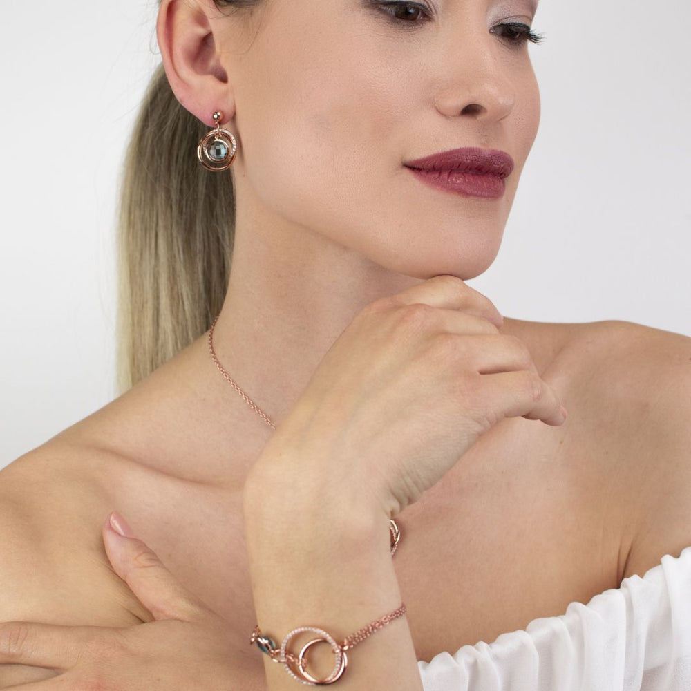 Shop online premium rose gold plated drop earrings with concentric circle design, sky blue stone and sparkling cubic zirconia accents for elegant styling.