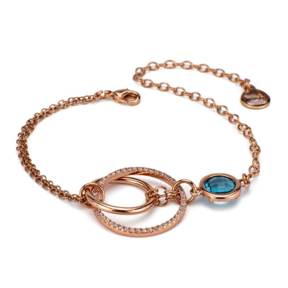 Elegant rose gold plated bracelet with concentric circle detailing, sparkling cubic zirconia, and a sky blue crystal accent. Perfect for luxe everyday styling. Shop premium jewelry online.