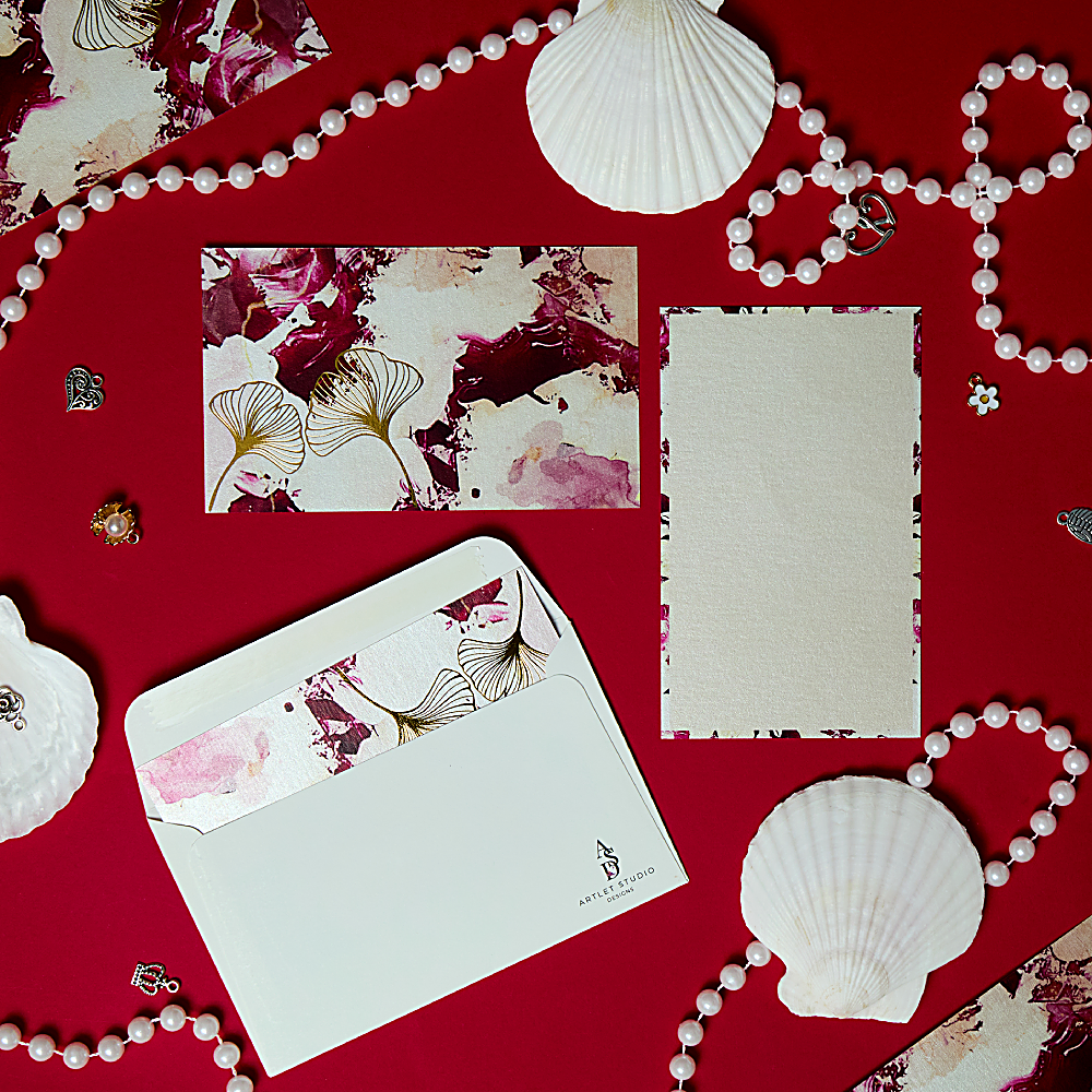 Discover Rosette Notecard at The Luxe Maison, featuring ivory and pink tones, gold-foil floral details, and matching textured envelopes. Pack of 10, made in Dubai.