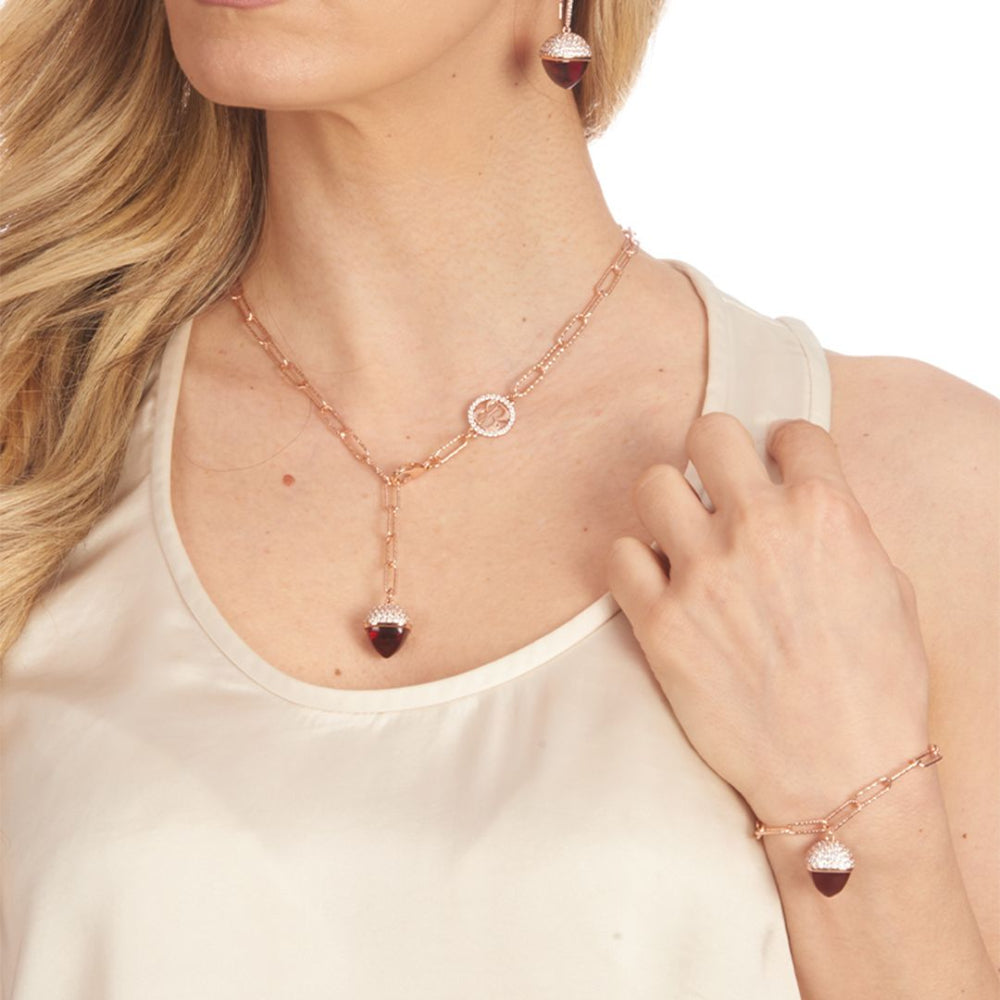 Elegant rose gold plated bracelet with a ruby-colored pyramid crystal pendant and sparkling cubic zirconia diamond-cut links. Perfect for luxe styling. Shop premium jewelry online.