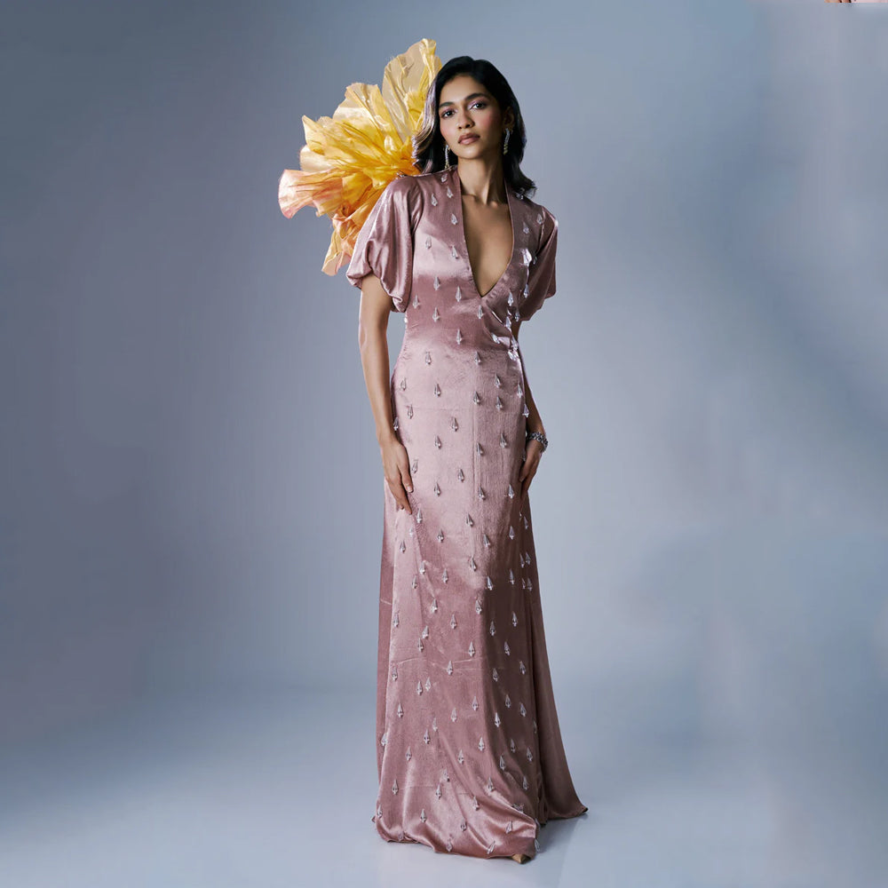 Peach satin maxi dress with V-neck, puff sleeves and crystal tassels, perfect for events. Shop online from our exclusive collection of premium styles.
