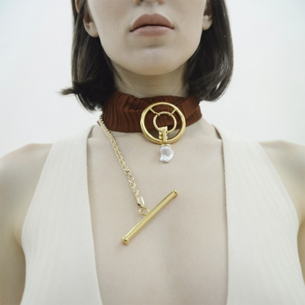 Statement baroque pearl choker on scarf.