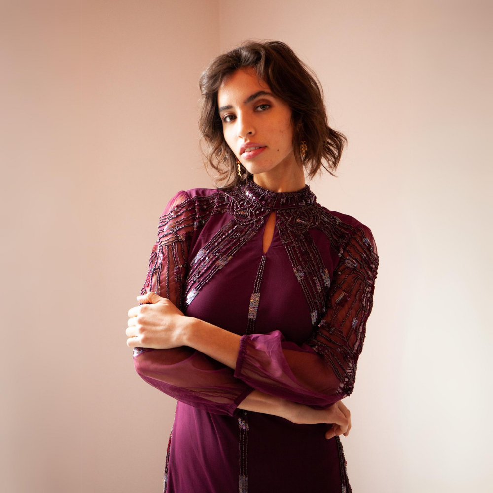 Stunning burgundy-coloured maxi gown with mesh sleeves and beading throughout.