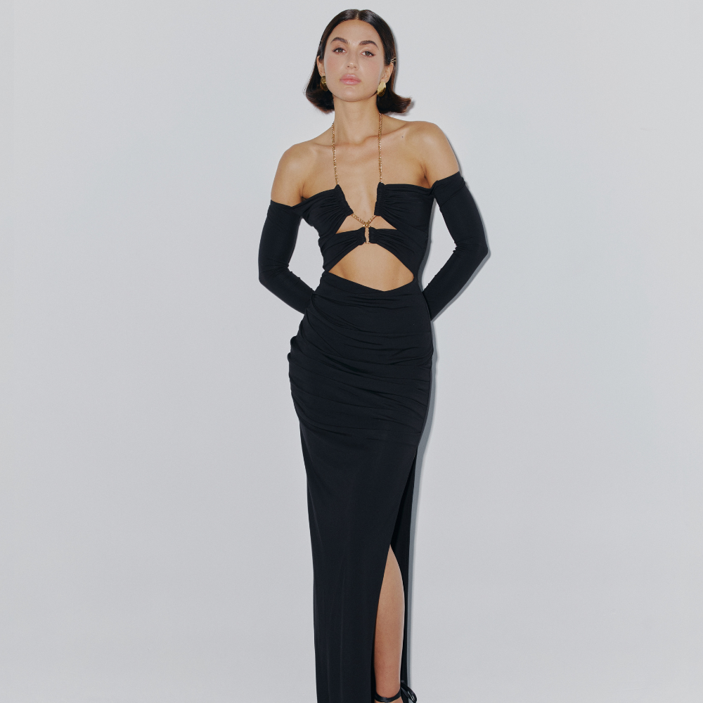 Turn heads in this stunning fitted dress with a chic gold chain and bold leg slit. Perfect for evenings and special occasions. Shop now at our exclusive clothing website.