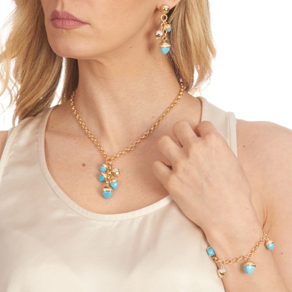 Elegant yellow gold plated necklace with knurled links and turquoise-colored pyramidal crystal pendants accented with sparkling cubic zirconia stones. Shop premium jewelry online.